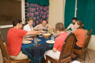 Volunteers enjoy a meal together after a hard day's work