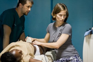 Volunteers Dr. John Simmons & Heidi Haun do an ultrasound on a patient